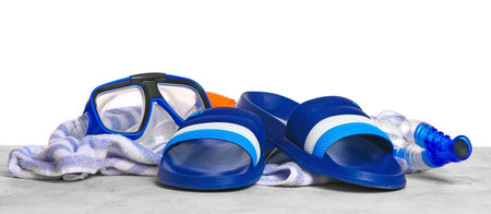 Set of beach accessories on table against white backgroundの写真素材