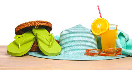 Set of beach accessories on table against white backgroundの写真素材