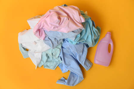 Dirty clothes and detergent on color backgroundの写真素材