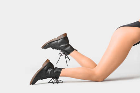 Beautiful young woman in tights on light backgroundの写真素材