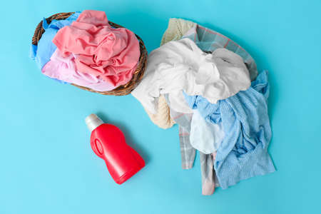 Dirty clothes and detergent on color backgroundの写真素材