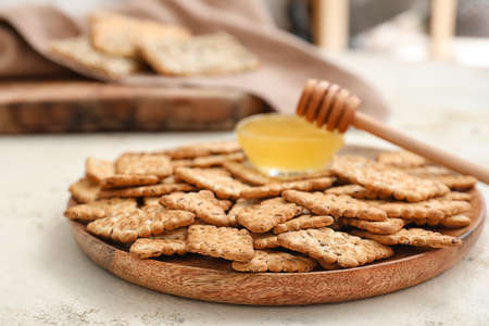 Plate with cereal cookies and honey on white backgroundの写真素材
