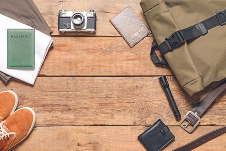 Set of travel accessories for men on wooden background