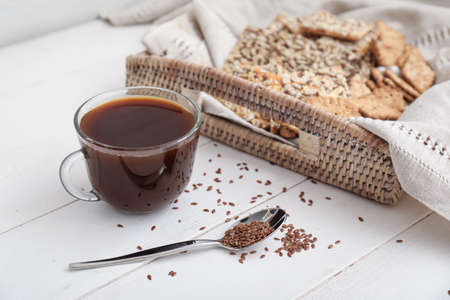 Tray with cereal cookies and cup of coffee on tableの写真素材