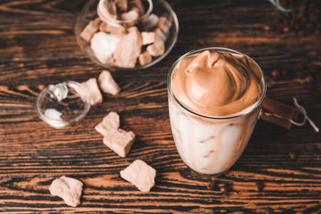 Glass of tasty dalgona coffee on tableの写真素材
