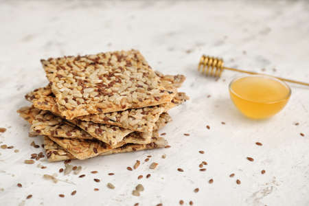 Cereal cookies and honey on white backgroundの写真素材