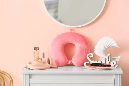 Travel pillow on chest of drawers in roomの写真素材
