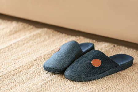 Pair of soft slippers on floorの写真素材