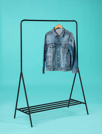 Stylish hanger with female clothes on color backgroundの写真素材