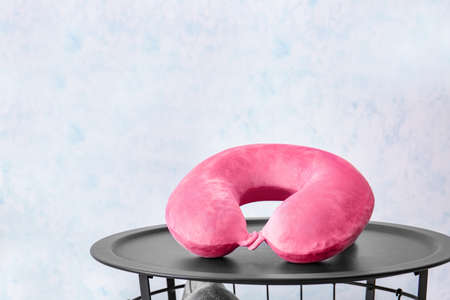 Travel pillow on table in roomの写真素材