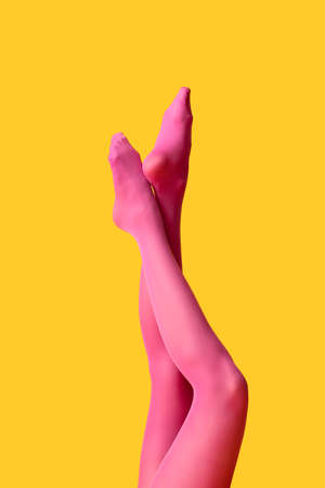 Beautiful young woman in tights on color backgroundの写真素材