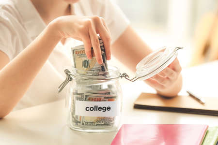 Girl with savings for education at homeの写真素材