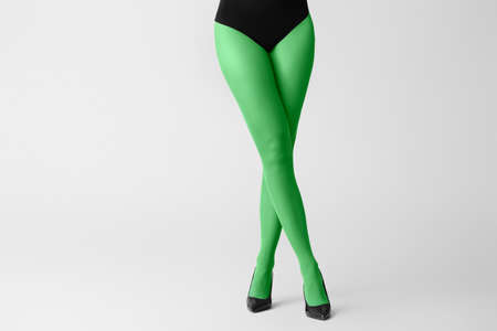 Beautiful young woman in tights on light backgroundの写真素材