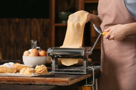 Woman preparing pasta in kitchen closeupの写真素材