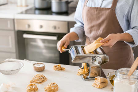 Woman preparing pasta in kitchen closeup