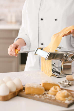 Woman preparing pasta in kitchen closeupの写真素材