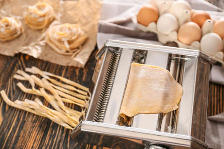 Preparing of pasta with machine on kitchen tableの写真素材