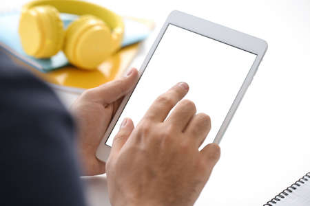 Young man using tablet computer for online learning at home