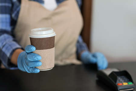Female barista in modern cafe, closeup. Concept of epidemicの写真素材