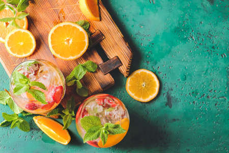 Glasses of fresh strawberry mojito on color backgroundの写真素材