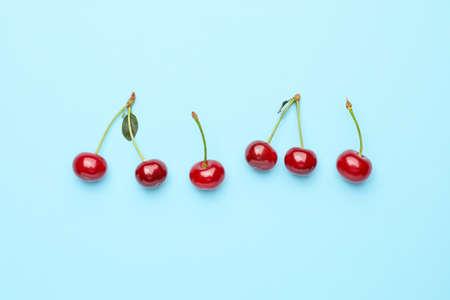 Ripe sweet cherry on color backgroundの写真素材