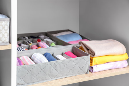 Organizers with clean clothes in closetの写真素材