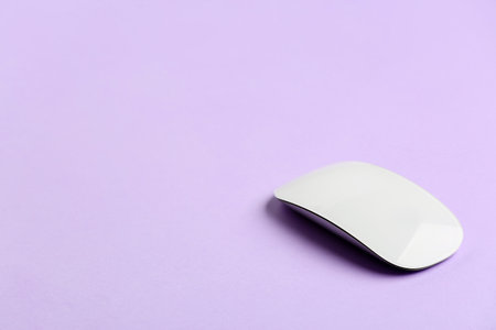 Modern computer mouse on color background