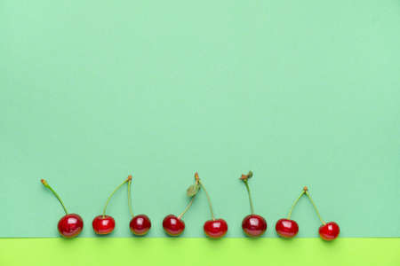 Ripe sweet cherry on color backgroundの写真素材