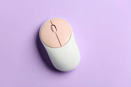 Modern computer mouse on color background