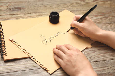 Woman practicing calligraphy at tableの写真素材