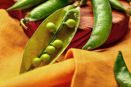 Board with tasty fresh peas on table, closeupの写真素材