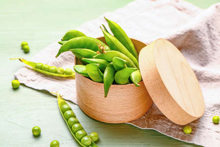 Box with tasty fresh peas on tableの写真素材