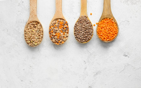 Spoons with lentils on white backgroundの写真素材