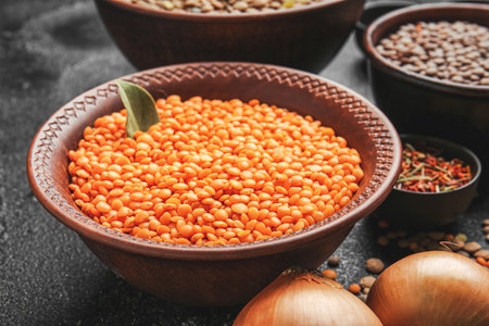 Bowl with lentils on dark background