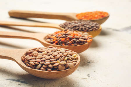 Spoons with lentils on white backgroundの写真素材