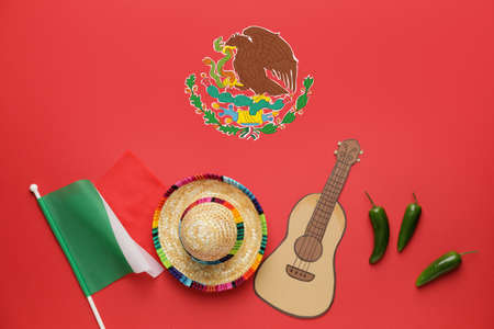 Sombrero hat with Mexican flag, guitar and chili peppers on color backgroundの写真素材