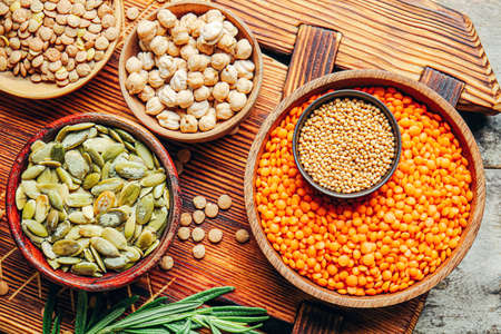 Different raw legumes with spices on tableの写真素材
