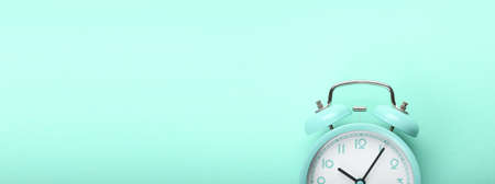 Alarm clock on color background with space for text