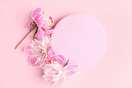 Beautiful peony flowers and blank card on color backgroundの写真素材