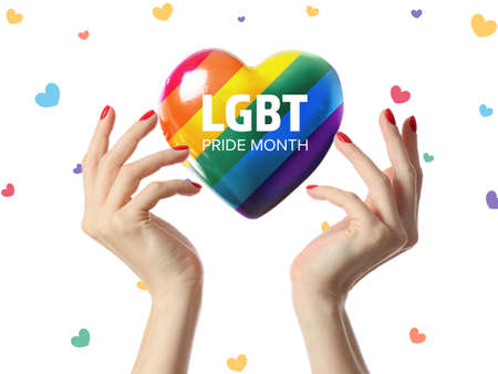 Hands and rainbow heart with text LGBT PRIDE MONTH on white backgroundの写真素材