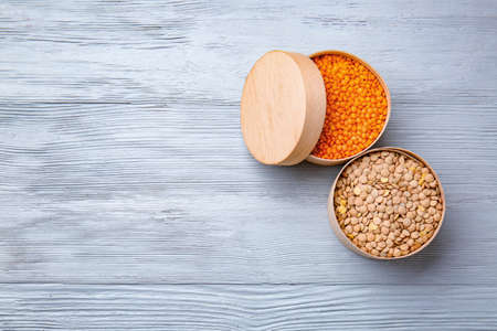 Boxes with raw lentils on tableの写真素材