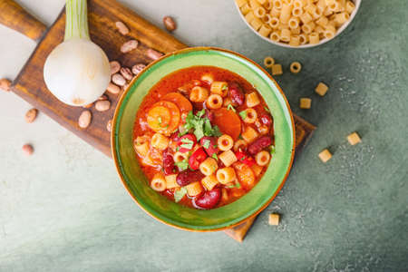 Bowl with tasty pasta and beans on tableの写真素材
