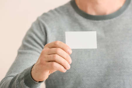 Man with blank business card, closeupの写真素材