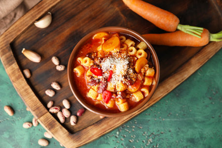 Bowl with tasty pasta and beans on color backgroundの写真素材