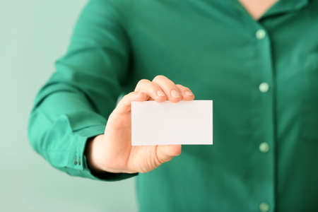 Woman with blank business card, closeup
