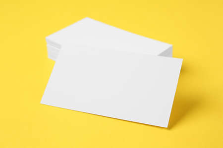 Blank business cards on color background