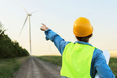 Female engineer on windmill farm for electric power production