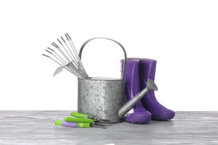 Gardening tools on table against white backgroundの写真素材