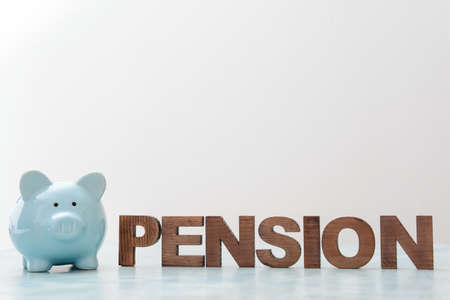 Piggy bank with word PENSION on light backgroundの写真素材