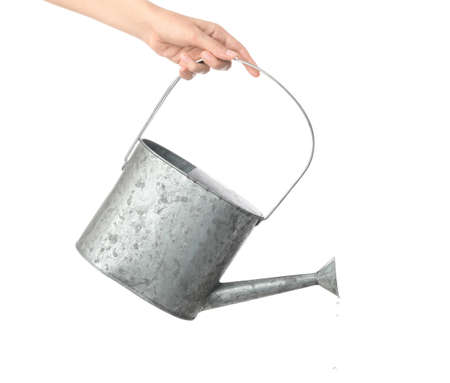 Hand with watering can on white backgroundの写真素材